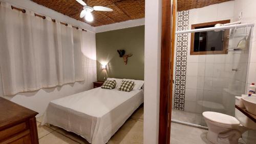 1 dormitorio con cama, ducha y aseo en Casa Canto dos Saíras, en Paraty