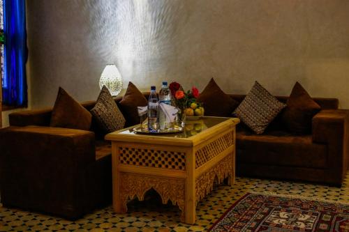 a living room with a couch and a table at Riad Al Fassia Palace in Fez