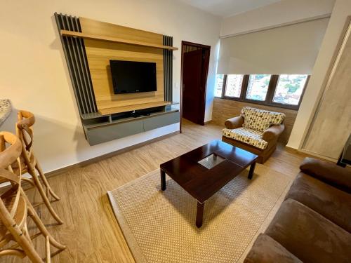 a living room with a couch and a tv at Sabe Center in Asuncion