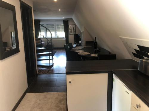 a kitchen with black and white cabinets and a dining room at The lion Bridge in Rogoźnik