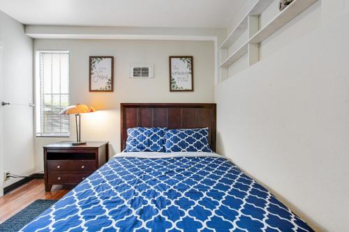 a bedroom with a bed with a blue comforter at Beacon Hill Hideaway in Seattle