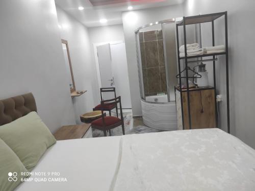 a bedroom with a bed and a bathroom with a tub at CEMRE SUIT in Istanbul