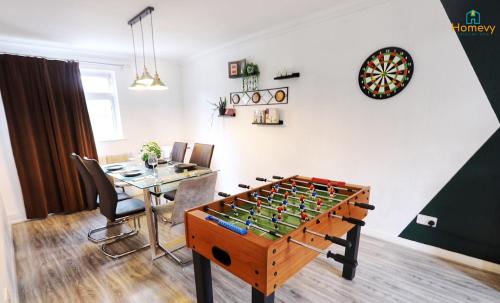 a room with a table and a game board at Stylish 3 bedroom house - Homevy Relocations in Birmingham