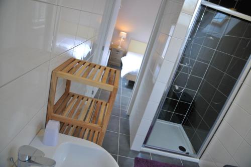 a bathroom with a toilet and a sink and a mirror at Petit coin de paradis in Somme-Leuze