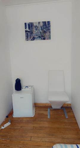 a bathroom with a toilet on a wooden floor at Clem in Calais