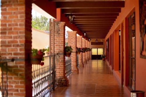 an empty hallway of a building with a brick wall at Villas San Francisco in Huichapan