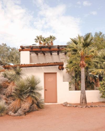a building with a door and a palm tree at The JTH Tucson in Tucson