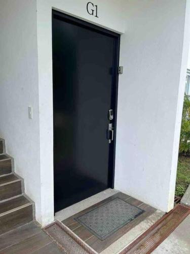 a black door with a sign on top of it at Lapa Lodge G1 in Jacó