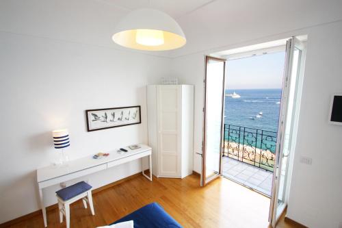 a living room with a view of the ocean at Capri Inn in Capri