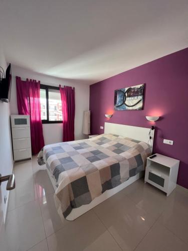 ロス・クリスティアーノスにあるApartment 409 El Carmenの紫の壁のベッドルーム(ベッド1台付)