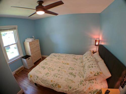 a bedroom with a bed and a ceiling fan at Harper Two Bedroom House in Historic Loveland in Loveland