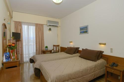 a bedroom with a large bed in a room at Hotel Nefeli in Volos