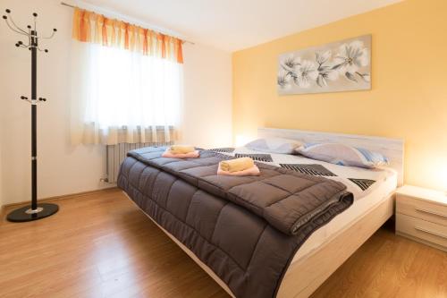 a bedroom with a large bed with blue pillows at Apartments for families with children Blaskovici, Central Istria - Sredisnja Istra - 12398 in Kršan