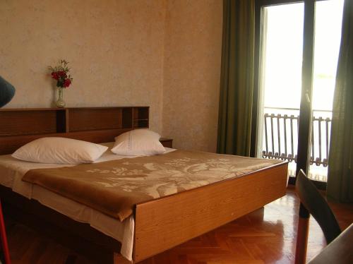 a bedroom with a large bed with a large window at Apartments with a parking space Brodarica, Sibenik - 12405 in Šibenik