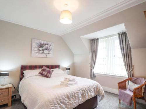 a bedroom with a bed and a window at Firthview in Buckie