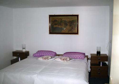two pigs laying on a bed in a bedroom at Apartments by the sea Sibenik - 12454 in Šibenik
