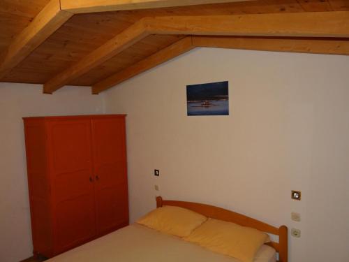 a bedroom with a bed and a red cabinet at Holiday house with a parking space Borje, Peljesac - 12506 in Orebić