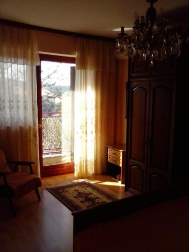 a living room with a window and a chandelier at Apartments with parking space Cres - 12609 in Cres