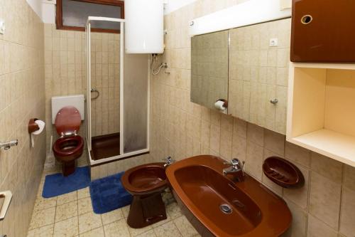a bathroom with two toilets and a sink at Apartments by the sea Mali Losinj (Losinj) - 12634 in Veli Lošinj