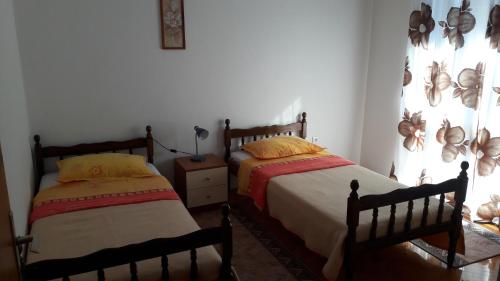 een slaapkamer met 2 bedden en een raam bij Apartments with a parking space Vinisce, Trogir - 12637 in Vinišće