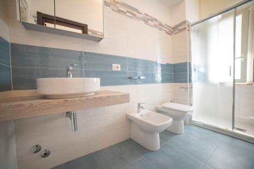 a bathroom with a sink and a toilet at Medoro Camere Milazzo in Milazzo