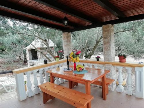 a table on the porch of a house at Secluded holiday house Cove Nevidjansko Polje, Pasman - 12806 in Neviđane