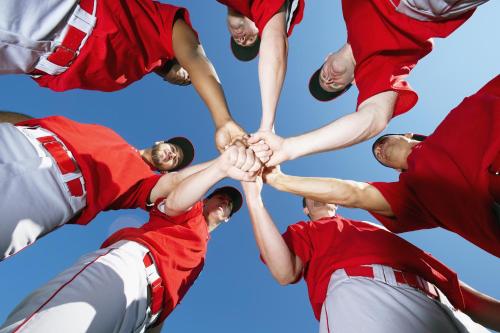 a group of baseball players holding their hands together at Country Inn & Suites by Radisson, Carlisle, PA in Carlisle