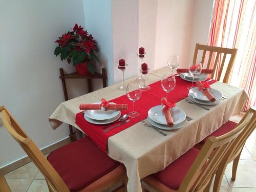 a dining room table with wine glasses and red napkins at Apartments by the sea Zman, Dugi otok - 12879 in Žman