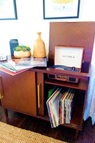 a wooden table with a laptop on top of it at Beachy Bungalow for Family Fun! Walk to beach! in Pensacola
