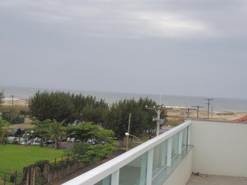 a balcony with a view of the ocean at Pousada Molhes da Barra in Torres
