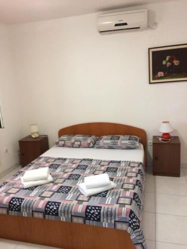 a bedroom with a bed with two towels on it at Apartments by the sea Zaostrog, Makarska - 12951 in Podaca