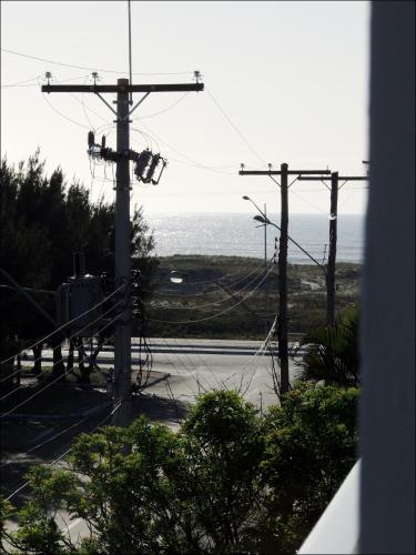 a view of a street with a view of the ocean at Pousada Molhes da Barra in Torres
