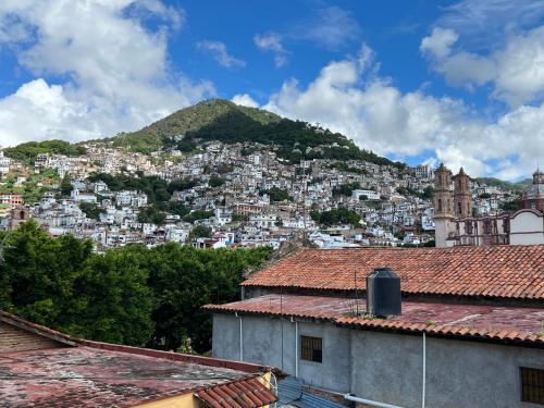 a view of a city with a mountain at Luna in Taxco de Alarcón
