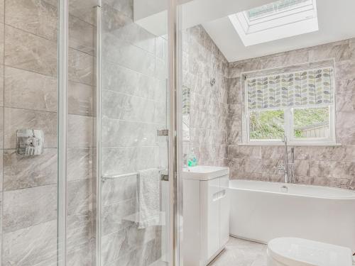 a bathroom with a shower and a toilet and a sink at The Beach House in Crantock
