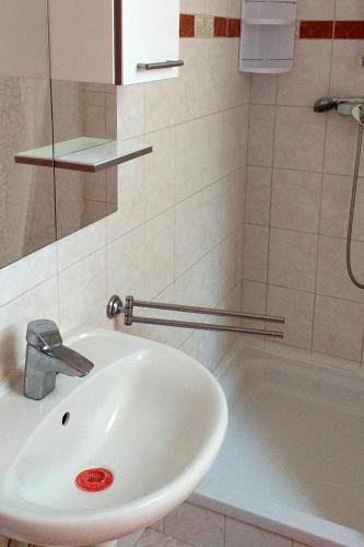 a bathroom with a white sink and a bath tub at Apartments with parking space Privlaka, Zadar - 12989 in Privlaka