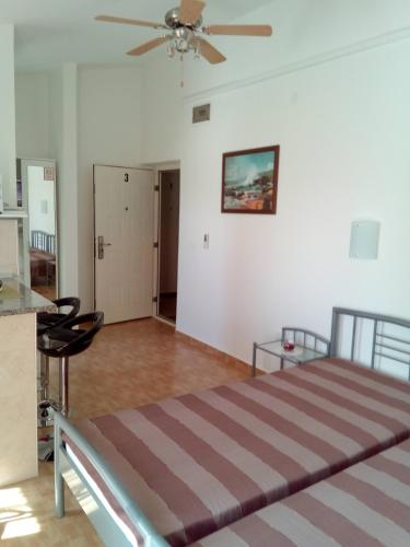 a bedroom with a bed and a ceiling fan at Apartments with a parking space Starigrad, Paklenica - 12992 in Starigrad