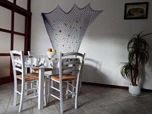 a dining room table with chairs and an umbrella at Apartments with WiFi Pula - 13049 in Pula