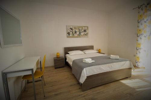 a bedroom with a bed and a desk in it at Apartments and rooms with parking space Pag - 13060 in Pag