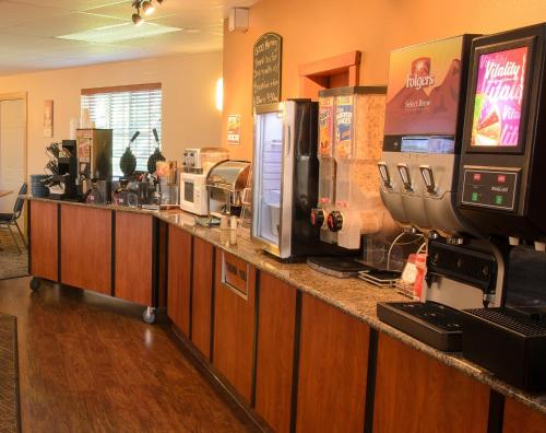 a bar in a restaurant with a counter top with coffee machines at North Star Hotel Pictured Rocks in Munising