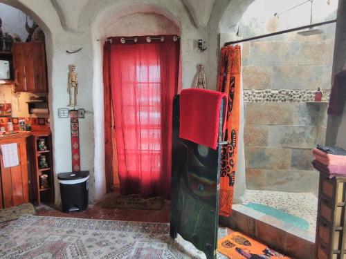 a room with a red curtain in a room at La Loma del chivo Llc- Na bolom in Marathon