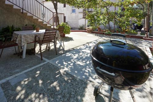 a motorcycle with a helmet parked next to a table at Apartments and rooms with parking space Trogir - 13102 in Trogir