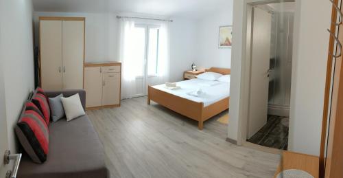 a bedroom with a bed and a room with a mirror at Apartments by the sea Bol, Brac - 13121 in Bol