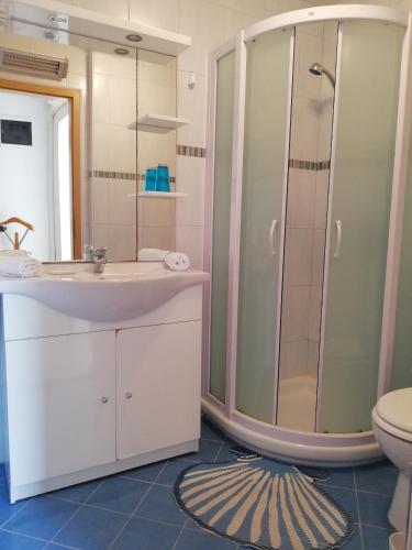 a bathroom with a sink and a shower at Apartments with parking space Rabac, Labin - 13151 in Rabac