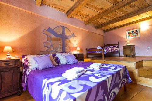 a bedroom with a bed with a cross on the wall at Rooms with a parking space Bratulici, Marcana - 13188 in Hreljići