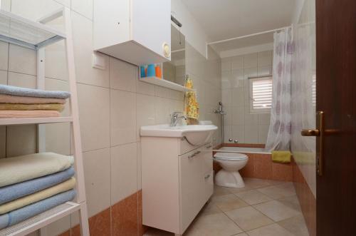 a small bathroom with a sink and a toilet at Apartments by the sea Karbuni, Korcula - 13217 in Prizba