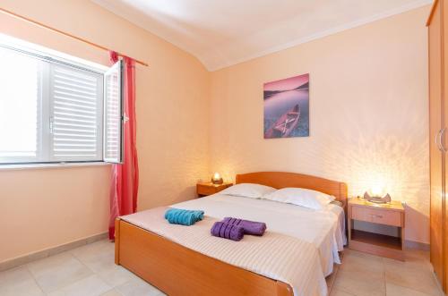 a bedroom with a bed and a window at Apartments by the sea Karbuni, Korcula - 13217 in Prizba