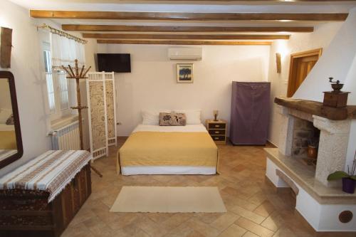 a bedroom with a bed and a fireplace at Apartments with a parking space Zagore, Opatija - 13277 in Mošćenička Draga