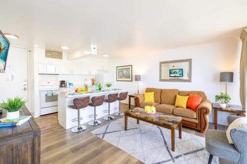 a living room with a couch and a kitchen at Beautiful Ocean and Diamond Head Views with Parking in Honolulu