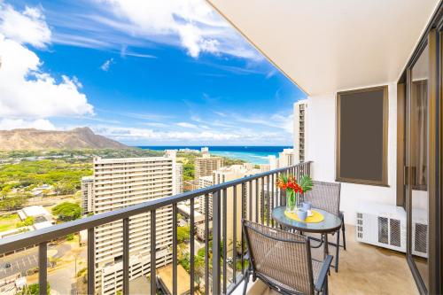 a balcony with a table and chairs and a view of the ocean at Beautiful Ocean and Diamond Head Views with Parking in Honolulu