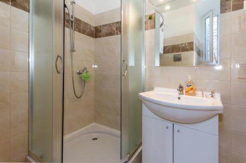 a bathroom with a sink and a shower at Apartments by the sea Rijeka - 13293 in Rijeka